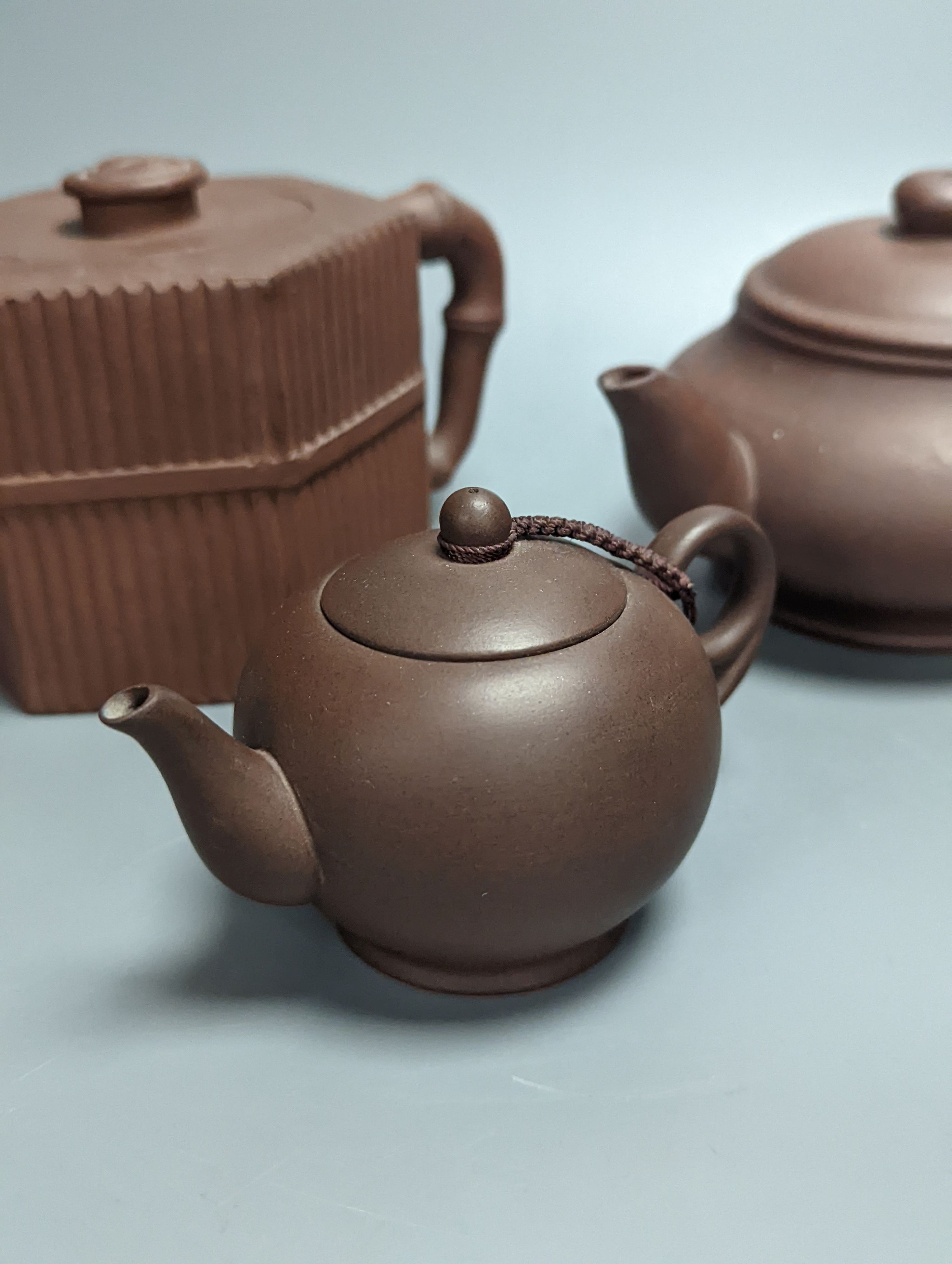 Three Chinese Yixing teapots, tallest 10.5cm